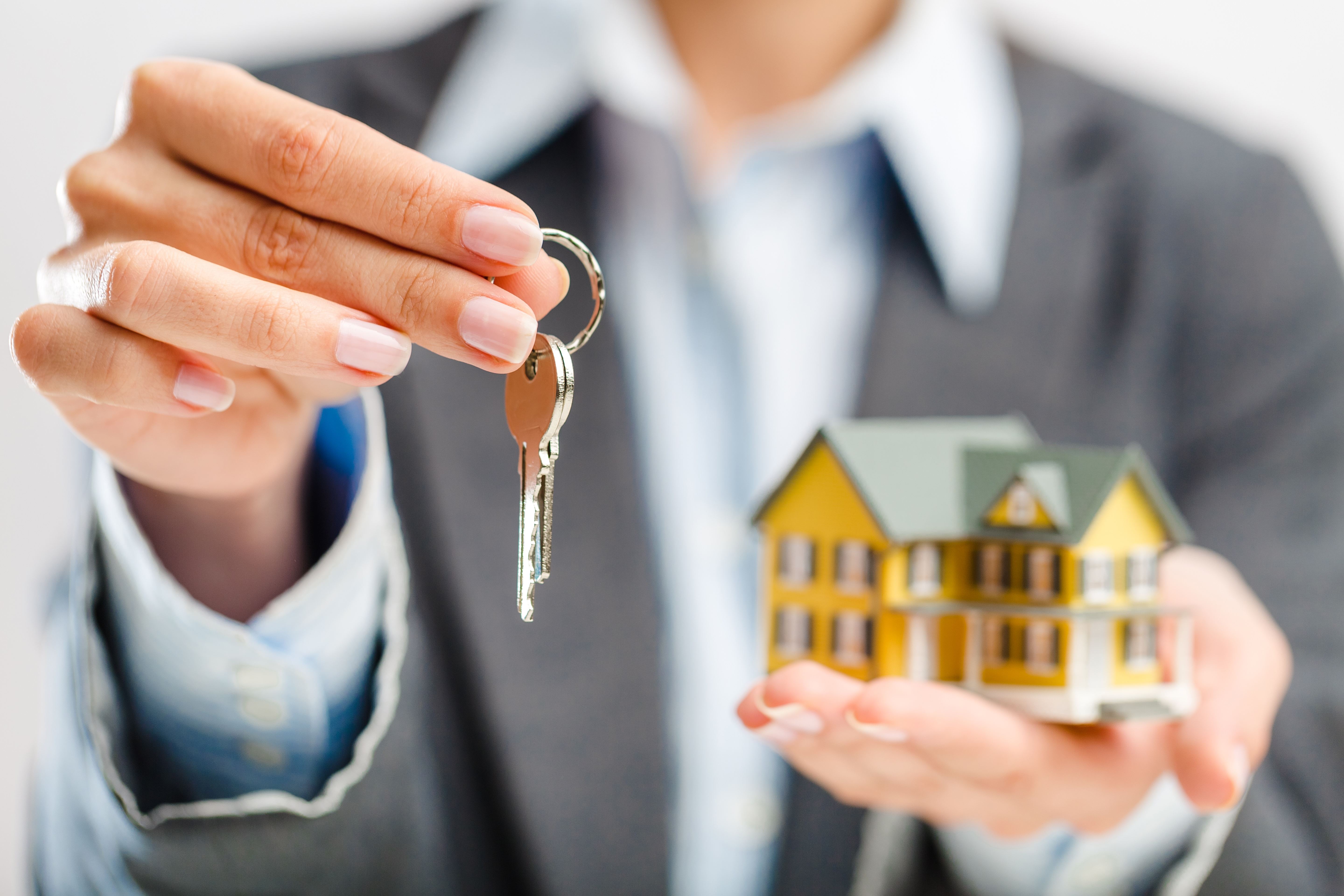 man holding keys to a home